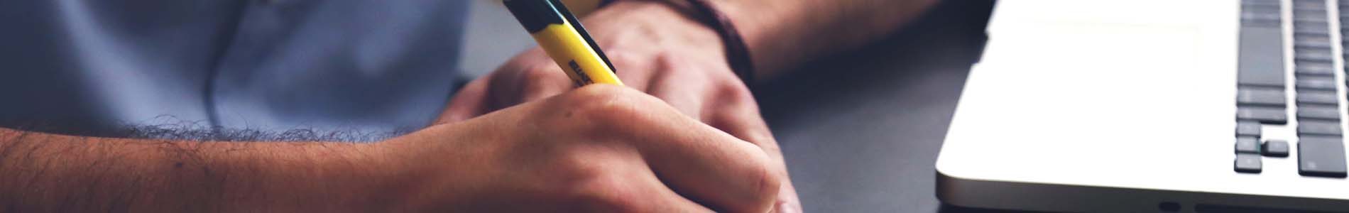 A Photo of a man taking notes.